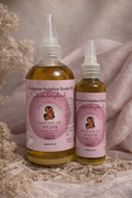 Two bottles of 'Essence of Sulphur' scalp oil, 100ml sand 200ml on a neutral background
