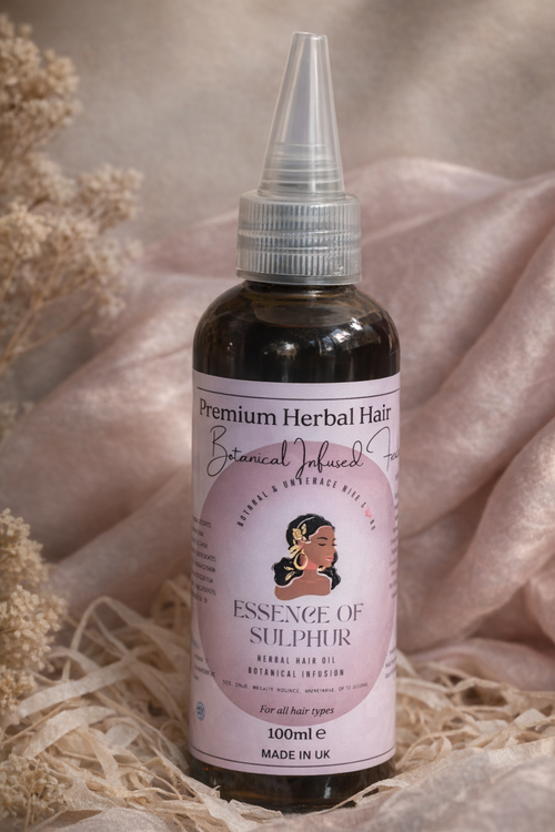 Bottle of 'Essence of Sulphur' herbal hair oil with a pink label on a soft beige background.
